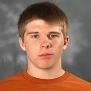 Unsmiling young man with short dark hair